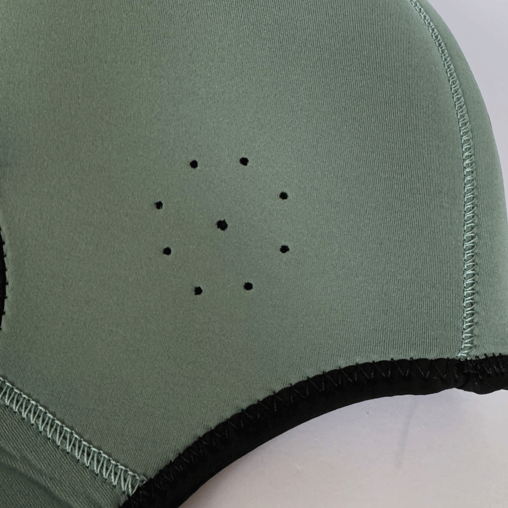 Close-up of a green Neoprene cap with black inside on a white background